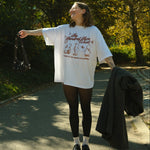 Person standing outdoors in a park with trees and sunlight