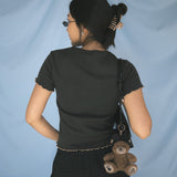 The Churro Bear Ruffle Trim Baby Tee in Vintage Black